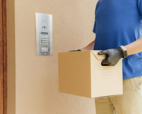 close-up-man-with-gloves-holding-box